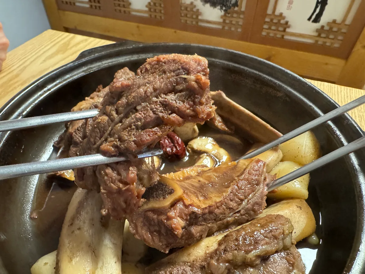 箸で持ち上げた骨付きカルビ