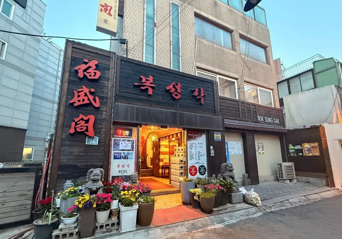 福盛閣 — 福盛閣の看板と花鉢が並ぶ入口