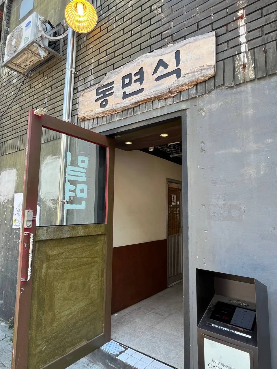 木の店名看板が掛かった入口
