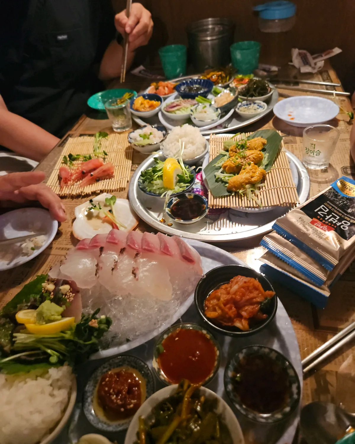 オハンロ 龍山本店 — 刺身や揚げ物が並ぶ食卓