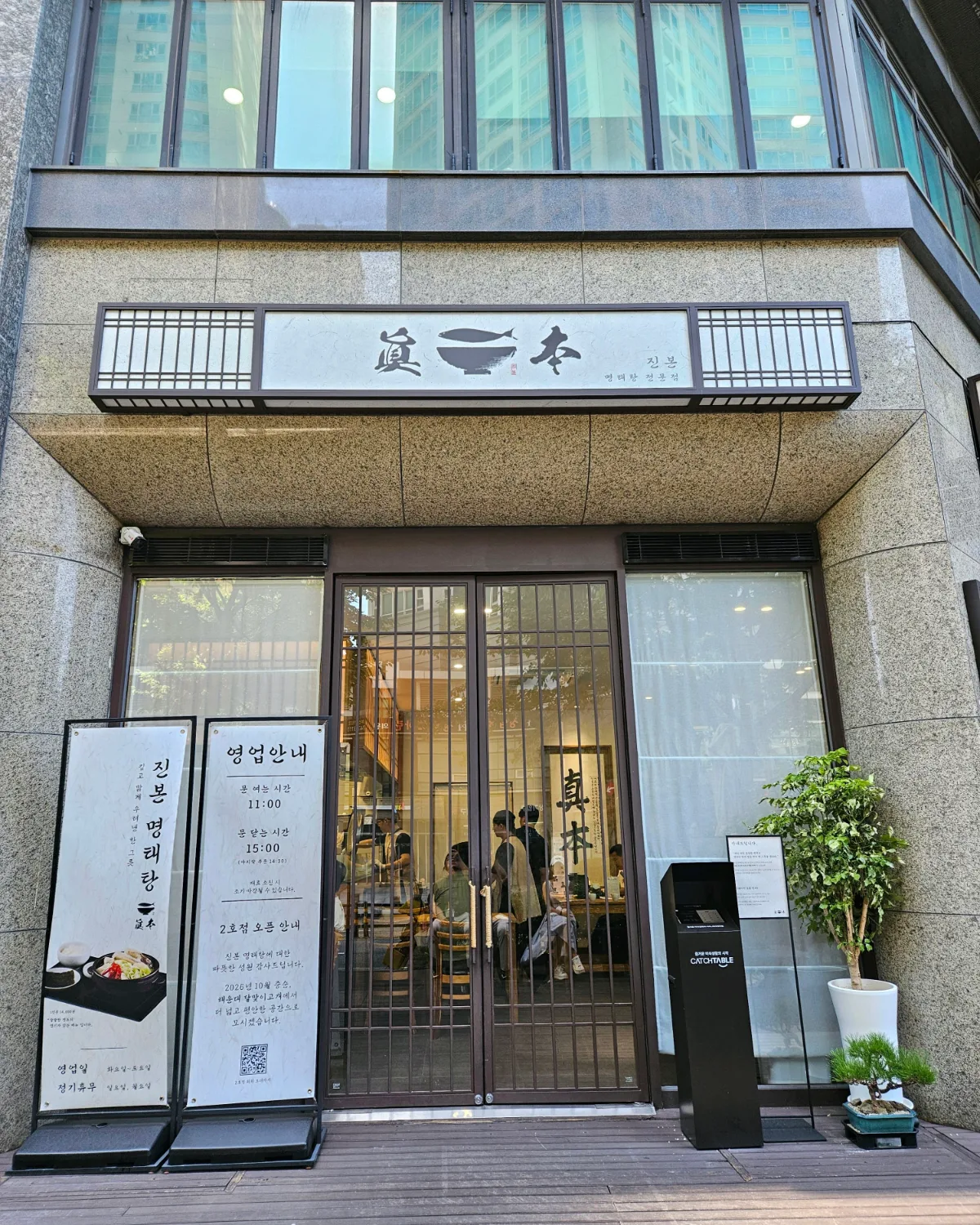 営業案内の立て看板が立つ入口