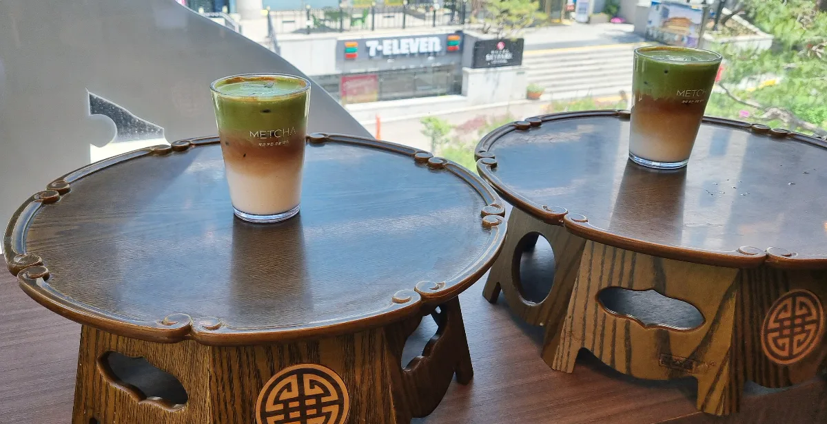 METCHA 明洞本店 — 窓辺の小さな膳と二杯のドリンク
