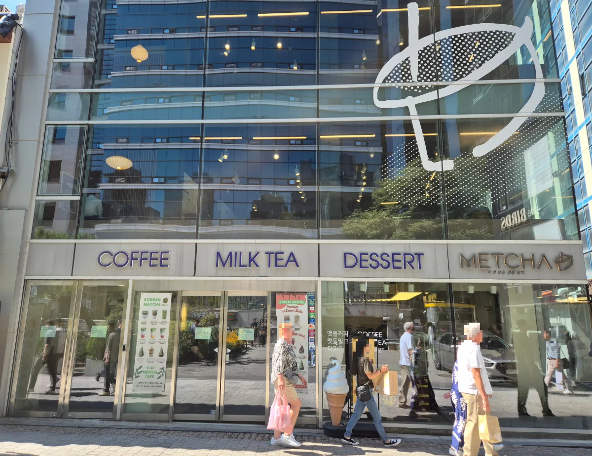 METCHA 明洞本店 — 大きな茶器の絵があるガラス張りの店
