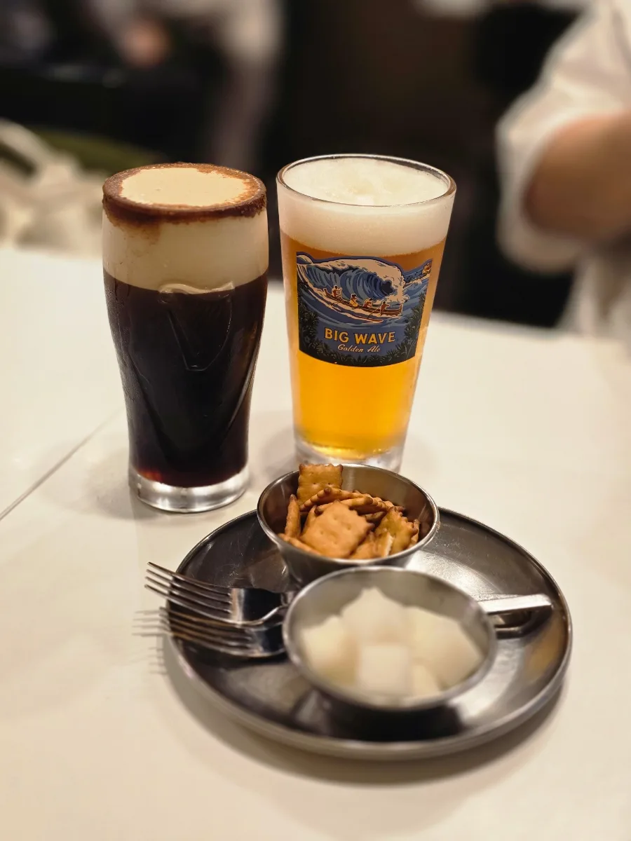 色の異なるビール二杯と大根の漬物