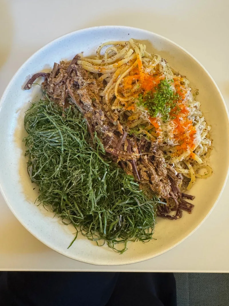 ODDHAUS — 細切りの葉と山菜を盛ったパスタ