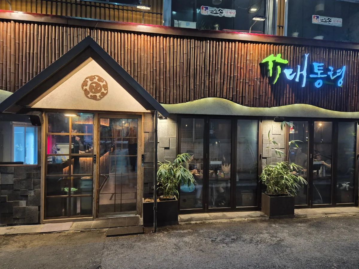 竹統領サムギョプサル 東大門店 — 竹のマークの看板が光る夜の外観