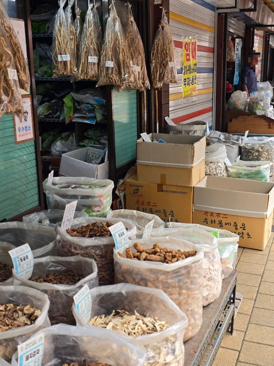 名札を付けた袋入りの薬材が並ぶ店先