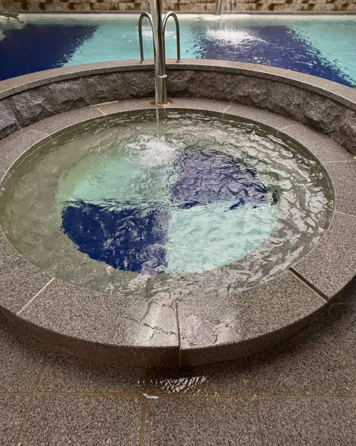 丸い浴槽と奥の大きな湯船