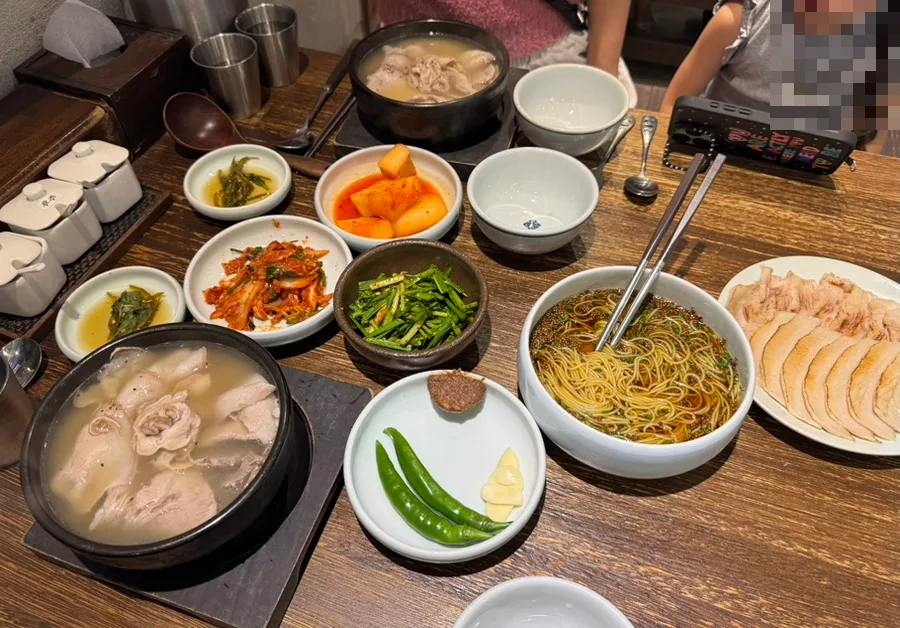 オムヨンベク・テジクッパ 海雲台店 — クッパと茹で豚が並ぶ食卓