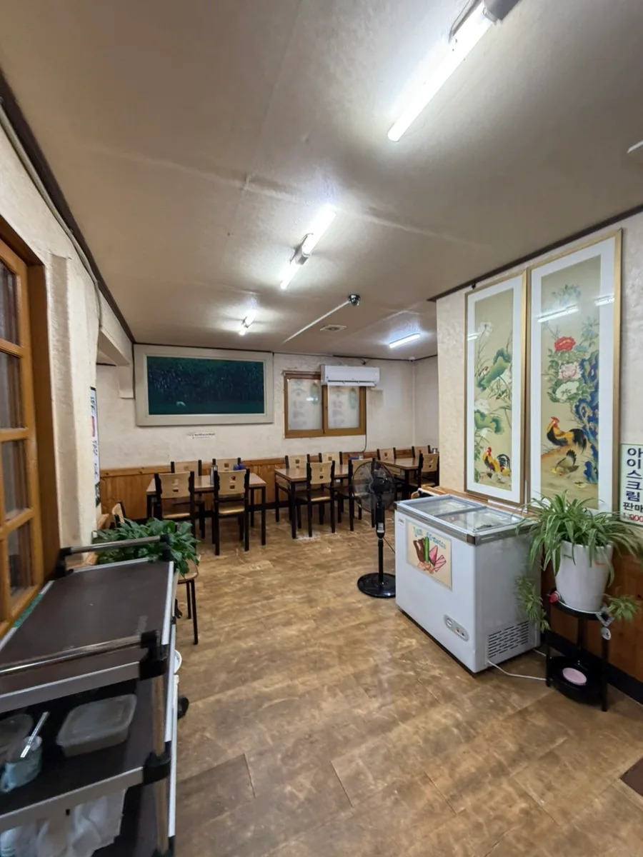 花鳥画とテーブルが並ぶ店内