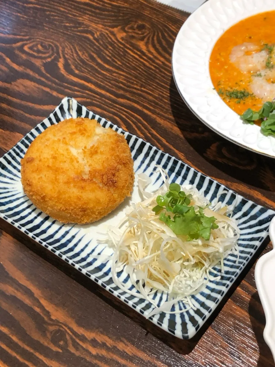 千切りキャベツを添えたポテトコロッケ