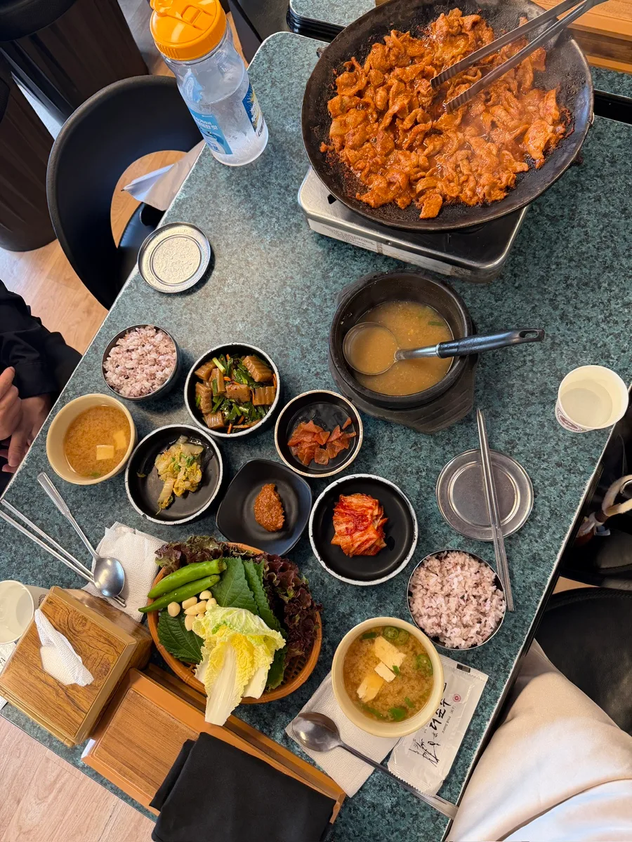ユジョン食堂(鶴洞) — 豚肉の炒め物と葉野菜が並ぶ食卓
